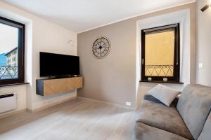 a living room with a couch and a clock on the wall at Le Lavande in Castro