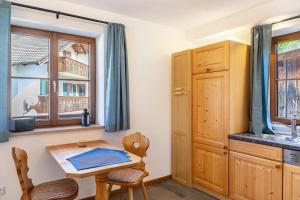 a kitchen with a small table and a window at Beim Schweizer in Garmisch-Partenkirchen