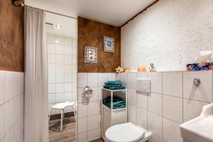 a bathroom with a toilet and a sink at Hof Islandpferde von der Holstenau in Eggstedt +40 photos