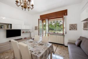 a dining room with a table and a television at La Casa Della Gioia - Serravalle in Serravalle Scrivia