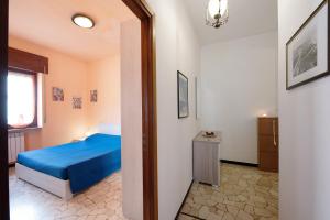 a bedroom with a blue bed and a window at La Casa Della Gioia - Serravalle in Serravalle Scrivia