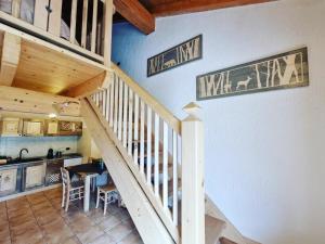 a staircase in a house with a kitchen and a dining room at Appartamento Adamello 7 in Pinzolo