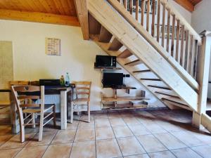 a dining room with a table and a staircase at Appartamento Adamello 7 in Pinzolo