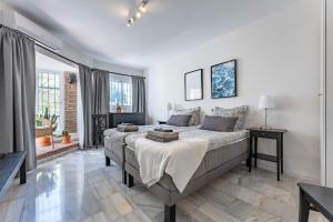 a bedroom with a bed and a large window at Holiday Villa Torrenueva in La Cala de Mijas +31 photos