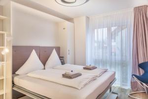 a bedroom with a bed and a large window at Apartment zum Genießen in Garmisch-Partenkirchen