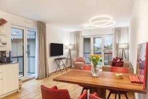a living room with a wooden table and chairs at Apartment zum Genießen in Garmisch-Partenkirchen