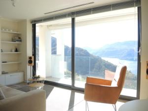 a living room with a couch and a large window at Italian Heaven in Perledo +4 photos
