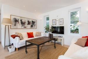 a living room with a white couch and a coffee table at Villa Jodie in Sóller