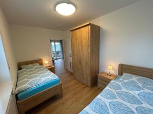 ein Schlafzimmer mit einem Bett und einem Holzschrank in der Unterkunft Seeblick in Versmold