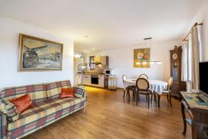 a living room with a couch and a table at Landhaus Kauderer - Wohnung 2 in Waging am See