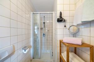 a bathroom with a shower and a mirror at Landhaus Kauderer - Wohnung 2 in Waging am See +24 photos