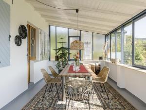 a dining room with a table and chairs and windows at Dorfhaus1953 in Eslohe +31 photos