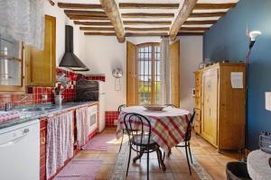 a kitchen with a table with a table cloth at La Ripa - Appartamento I Nidi in San Gimignano