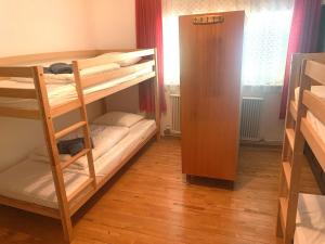 a room with two bunk beds and a closet at Ferienwohnung Durst 1 in Mayrhofen
