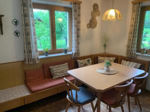 a dining room with a table and a couch at Ferienwohnung Durst 1 in Mayrhofen