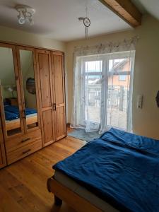 a bedroom with a bed and a large sliding glass door at Ferienwohnung Dorfprozelten in Dorfprozelten