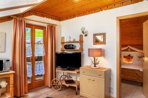 a living room with a television and a bedroom at Ferienhaus St Christoph in Mittenwald