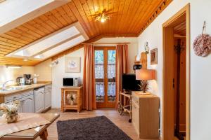 a kitchen with a wooden ceiling and a table at Ferienhaus St Christoph in Mittenwald