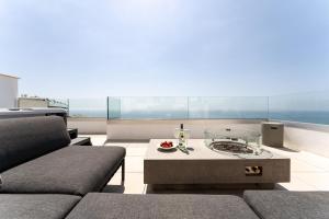a living room with a couch and a table at Luxury Penthouse with Rooftop in Fuengirola