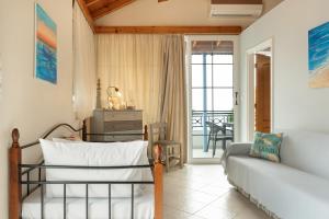 a living room with a bed and a couch at Niki's Studios Kalymnos in Kalymnos