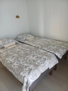 two beds sitting next to each other in a room at Järvemetsa Stay in Dejevo +8 photos
