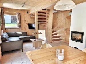 a living room with a couch and a fireplace at Chalet Martina in Stadl an der Mur