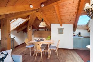 a kitchen and dining room with a table and chairs at Dimora La Rocca in Daiano +19 photos