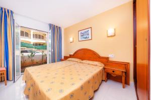 a bedroom with a bed and a large window at Apartamento Espiga in Cala Bona +18 photos