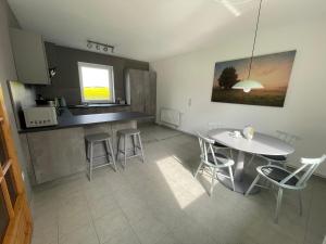 a kitchen with a table and chairs in a room at Kleines Haus am Feld in Rehna
