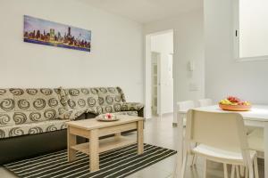 a living room with a couch and a table at 1a Van Halen in Vecindario
