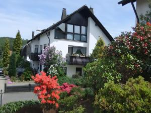 a house with flowers in front of it at Apartment Neuenrade in Neuenrade