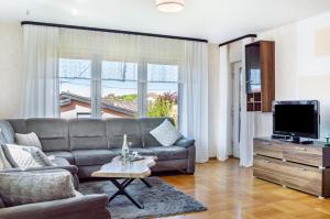 a living room with a couch and a tv at Fewo Kleinert in Billingsbach