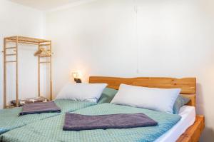 a bedroom with a bed with two towels on it at Fewo Kleinert in Billingsbach