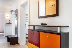 a room with a dresser and a mirror on the wall at Fewo Kleinert in Billingsbach +15 photos