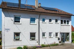 a white house with solar panels on the roof at Fewo Kleinert in Billingsbach