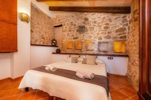 a bedroom with a bed in a stone wall at Ses Solls in Petra +21 photos
