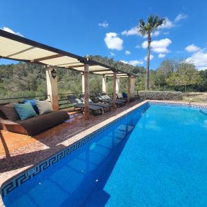 a swimming pool with a pergola and a swimming pool at Ses Solls in Petra