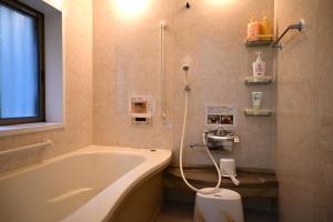 a bathroom with a bath tub and a shower at 心宿 伏見稲荷 in Kyoto +20 photos