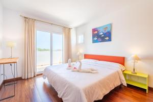 a bedroom with two stuffed animals on a bed at Casa La Siesta in Cala d´Or +18 photos