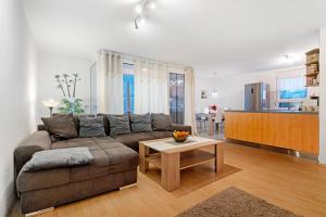 a living room with a couch and a table at Ferienwohnung Rheinvorland in Linx