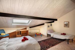 a attic bedroom with two beds and a skylight at Villa Bella Vista in Imperia