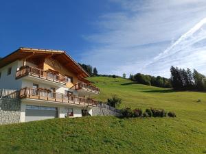 a house on the side of a green hill at Ederhof in Schenna