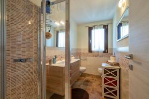 a bathroom with a shower and a sink and a toilet at La Casa di Valverde in Alghero