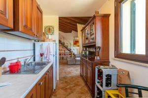 a kitchen with a sink and a refrigerator at La Casa di Valverde in Alghero +14 photos