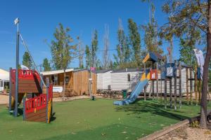 a playground with a slide in a park at Le Mediterranéen in Fréjus