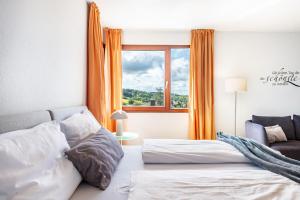 a bedroom with two beds and a window at Die Ferienwohnung in Bad Bellingen