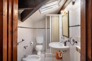 a bathroom with a toilet and a sink at Villa Bella Vista in Imperia +44 photos