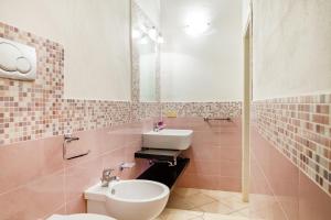 a bathroom with a toilet and a sink at Palmiro in Castiglione della Pescaia +20 photos