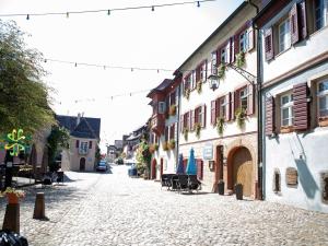 an empty street in a town with buildings and chairs at Schmiede Burkheim in Vogtsburg