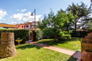 a house with a yard with a lawn sidx sidx sidx at Palmiro in Castiglione della Pescaia